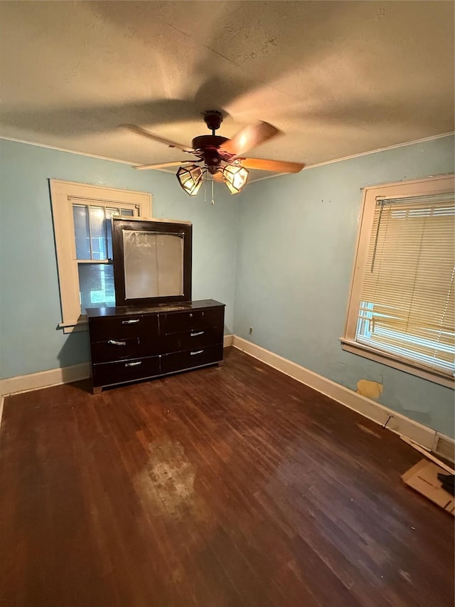 208 E 16th St, Des Moines, IA 50316 - unfurnished bedroom featuring dark wood-type flooring, a textured ceiling, and ceiling fan