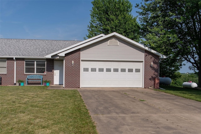 106 Park Ridge Dr, Otley, IA 50214 - ranch-style house featuring brick siding, driveway, a front yard, and a garage