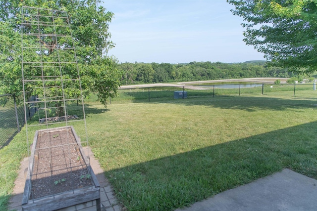 106 Park Ridge Dr, Otley, IA 50214 - view of yard featuring a vegetable garden and a water view