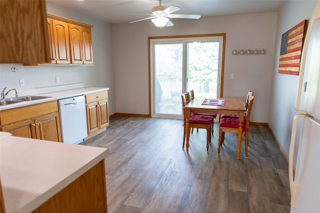 106 Park Ridge Dr, Otley, IA 50214 - kitchen featuring white appliances, ceiling fan, light countertops, brown cabinetry, and wood finished floors