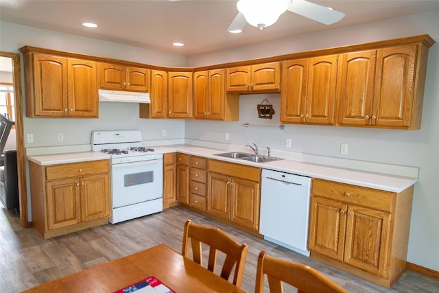 106 Park Ridge Dr, Otley, IA 50214 - kitchen with white appliances, under cabinet range hood, light countertops, brown cabinetry, and recessed lighting
