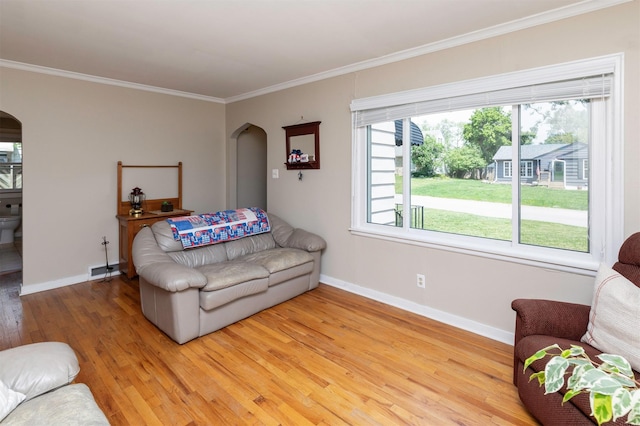 1808 60th St, Des Moines, IA 50322 - living room with arched walkways, light wood finished floors, and crown molding