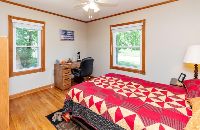 1808 60th St, Des Moines, IA 50322 - bedroom featuring light wood-style floors, multiple windows, ornamental molding, and ceiling fan