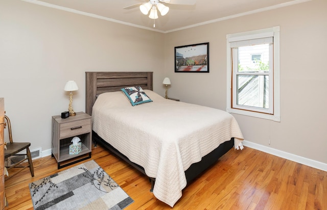 1808 60th St, Des Moines, IA 50322 - bedroom with crown molding, light wood finished floors, and a ceiling fan