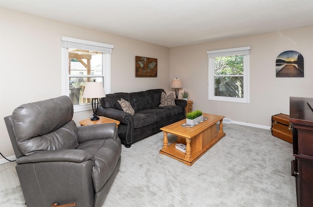 1808 60th St, Des Moines, IA 50322 - living room featuring baseboards and light colored carpet