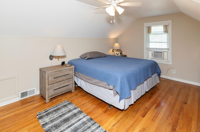 1808 60th St, Des Moines, IA 50322 - bedroom with light wood-style floors, vaulted ceiling, ceiling fan, and cooling unit
