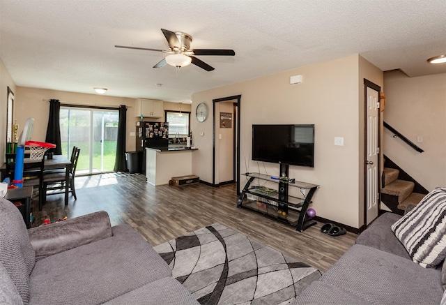 4505/4507 51st St, Des Moines, IA 50310 - living room featuring stairway, a ceiling fan, dark wood-type flooring, and a textured ceiling