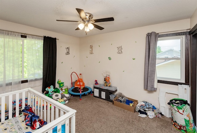 4505/4507 51st St, Des Moines, IA 50310 - bedroom featuring carpet, a crib, a ceiling fan, and a textured ceiling
