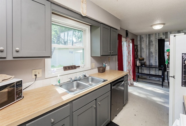 4505/4507 51st St, Des Moines, IA 50310 - kitchen with black microwave, dishwasher, gray cabinets, light countertops, and a textured ceiling