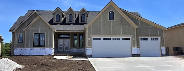 4617 Centennial Blvd, Urbandale, IA 50323 - view of front of house with a shingled roof, concrete driveway, and a garage