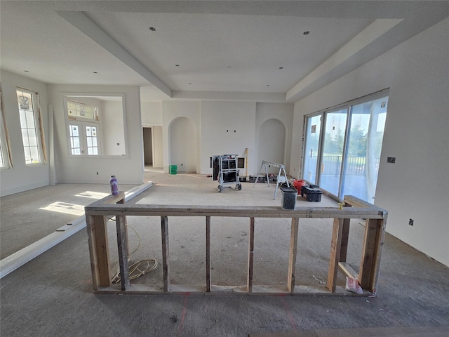 4617 Centennial Blvd, Urbandale, IA 50323 - kitchen with arched walkways, carpet floors, a tray ceiling, and a kitchen island