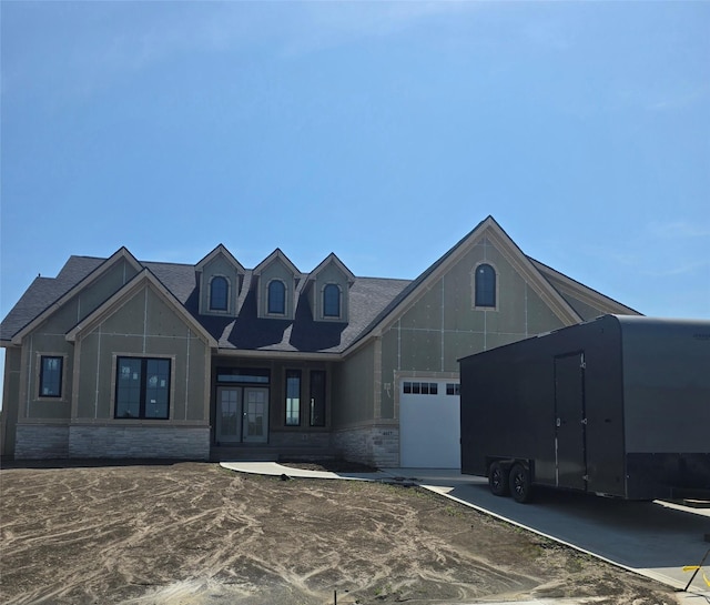 4617 Centennial Blvd, Urbandale, IA 50323 - view of front of home with french doors, stone siding, a garage, and a shingled roof