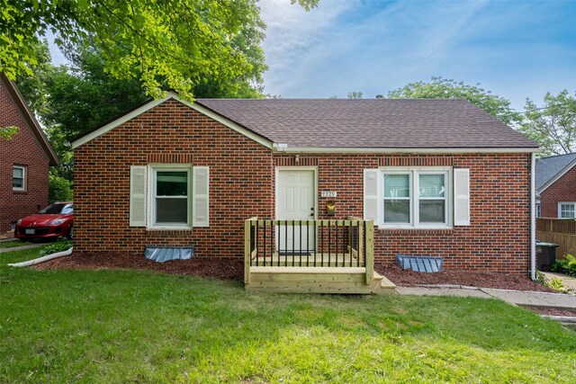1329 63rd St, Des Moines, IA 50311 - bungalow-style home featuring brick siding, a shingled roof, and a front yard