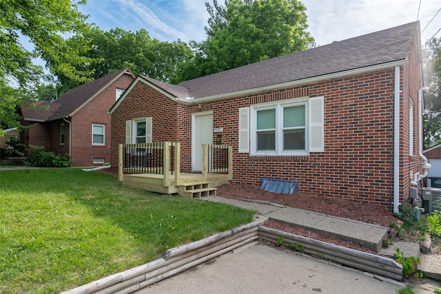 1329 63rd St, Des Moines, IA 50311 - view of front of house featuring brick siding, a front lawn, a wooden deck, and roof with shingles