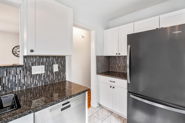 1329 63rd St, Des Moines, IA 50311 - kitchen with appliances with stainless steel finishes, decorative backsplash, white cabinetry, and light marble finish floors