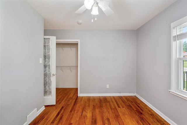 1329 63rd St, Des Moines, IA 50311 - unfurnished bedroom with a closet, wood finished floors, and ceiling fan