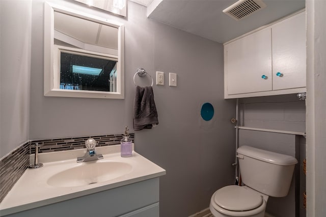 1329 63rd St, Des Moines, IA 50311 - half bathroom featuring vanity and tasteful backsplash