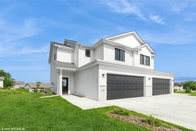 7000 Lake Hill Dr Unit 74, Des Moines, IA 50320 - view of front facade with driveway, a front yard, an attached garage, and brick siding