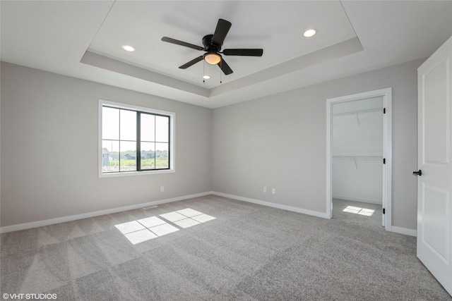 7000 Lake Hill Dr Unit 74, Des Moines, IA 50320 - unfurnished bedroom featuring a tray ceiling, recessed lighting, light colored carpet, a spacious closet, and a closet