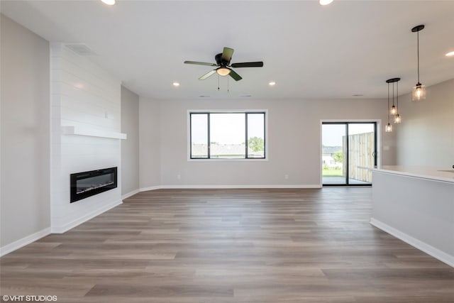 7000 Lake Hill Dr Unit 74, Des Moines, IA 50320 - unfurnished living room featuring recessed lighting, ceiling fan, wood finished floors, and a fireplace