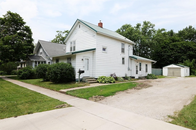 615 11th St, Boone, IA 50036 - view of side of home with a chimney, a garage, a lawn, entry steps, and a storage unit