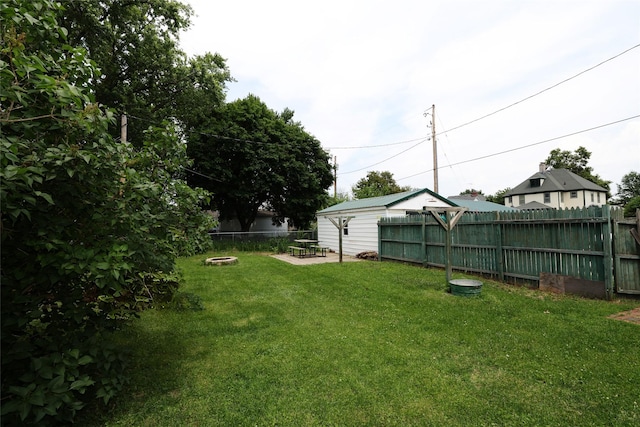 615 11th St, Boone, IA 50036 - fenced backyard with an outdoor fire pit