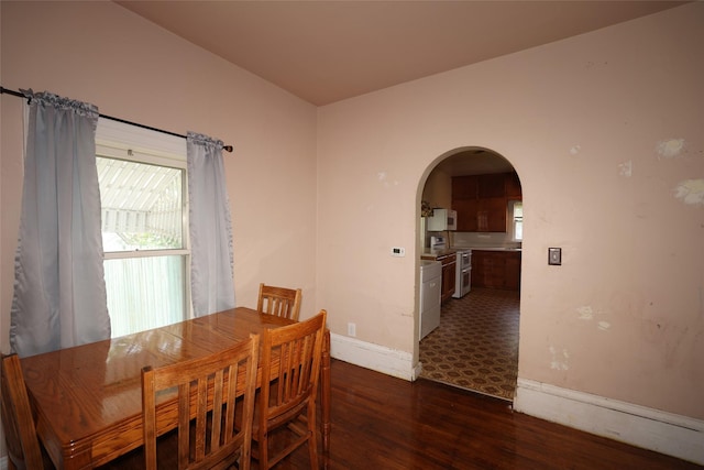 615 11th St, Boone, IA 50036 - dining space with arched walkways and dark wood-style flooring
