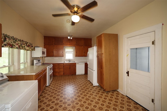 615 11th St, Boone, IA 50036 - kitchen with white appliances, washer / clothes dryer, brown cabinets, and light countertops