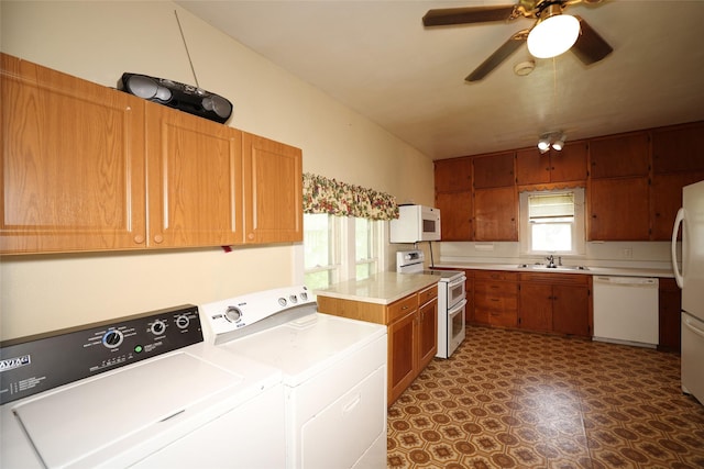 615 11th St, Boone, IA 50036 - kitchen featuring white appliances, washer and dryer, light countertops, ceiling fan, and brown cabinetry