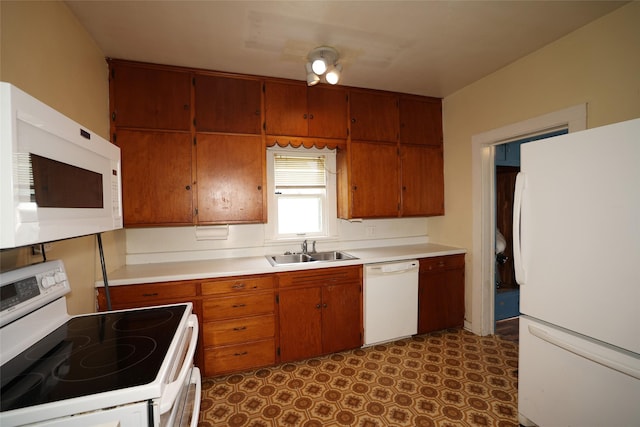 615 11th St, Boone, IA 50036 - kitchen with white appliances, light countertops, brown cabinetry, and dark floors