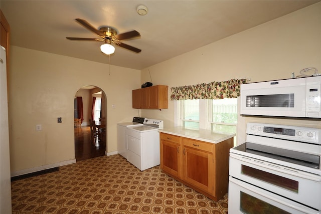 615 11th St, Boone, IA 50036 - kitchen featuring white appliances, separate washer and dryer, arched walkways, a ceiling fan, and dark floors
