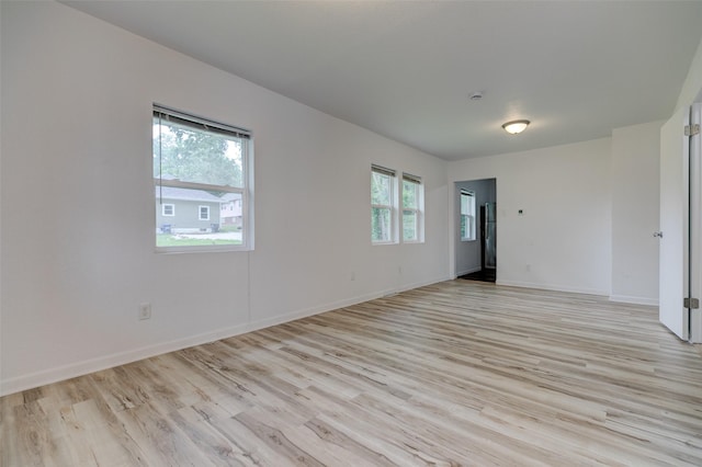 1512 2nd Pl, Des Moines, IA 50314 - spare room featuring light wood-style floors and baseboards