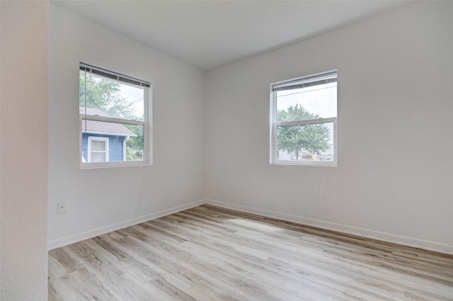 1512 2nd Pl, Des Moines, IA 50314 - empty room with healthy amount of natural light and light wood-style flooring