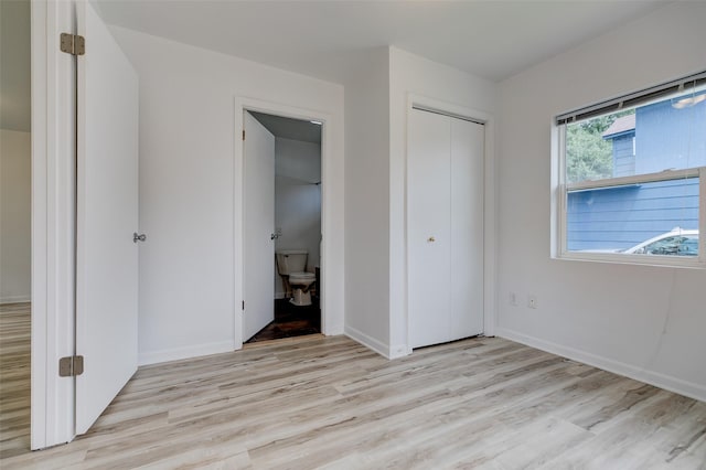 1512 2nd Pl, Des Moines, IA 50314 - unfurnished bedroom featuring light wood finished floors and a closet