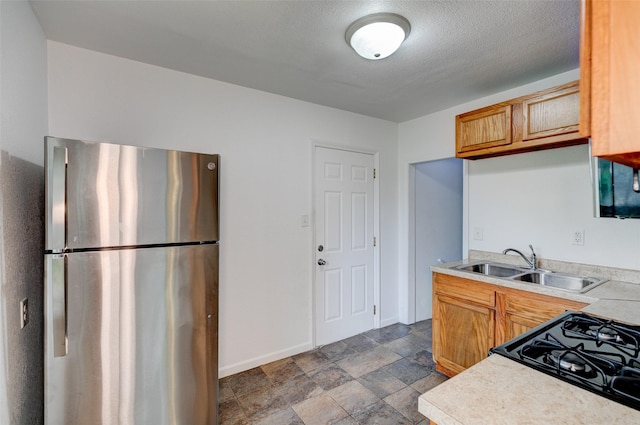 1512 2nd Pl, Des Moines, IA 50314 - kitchen featuring freestanding refrigerator, stove, light countertops, and dark stone finish flooring