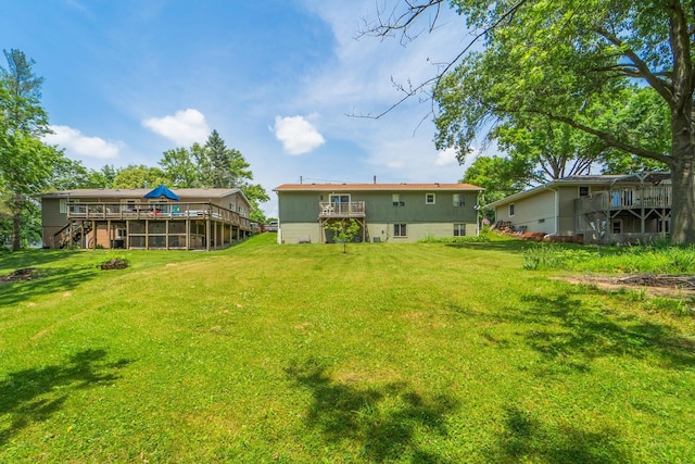 516 Walnut St, De Soto, IA 50069 - view of green lawn with a deck and stairs