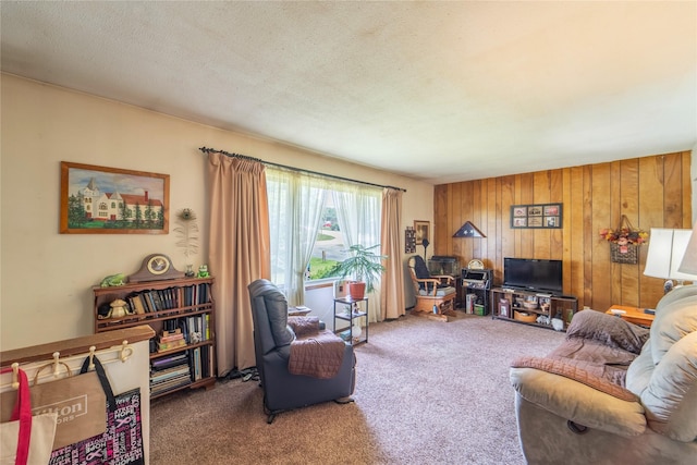 516 Walnut St, De Soto, IA 50069 - carpeted living room featuring wood walls and a textured ceiling