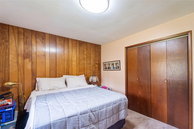516 Walnut St, De Soto, IA 50069 - carpeted bedroom with a closet and wooden walls
