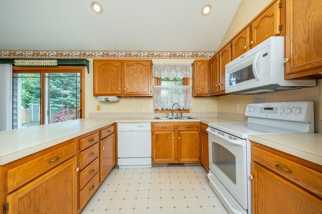 5145 Sycamore Dr, Pleasant Hill, IA 50327 - kitchen with white appliances, light flooring, light countertops, brown cabinetry, and lofted ceiling