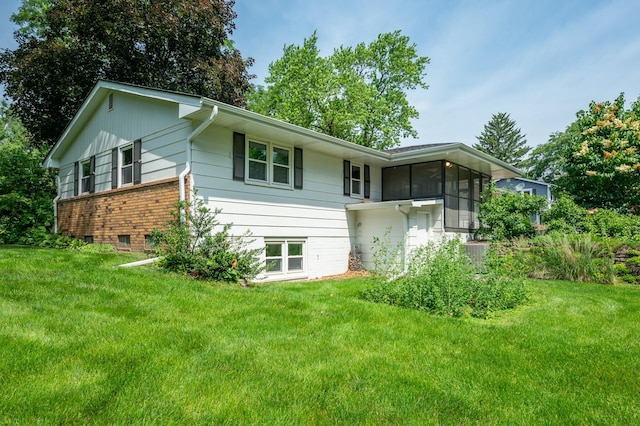 1005 32nd St, West Des Moines, IA 50266 - rear view of house with a yard and a sunroom