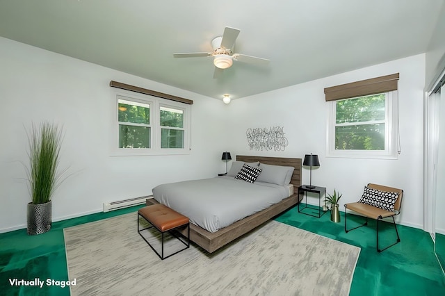 1005 32nd St, West Des Moines, IA 50266 - bedroom featuring baseboard heating, a closet, and ceiling fan