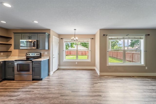 611 Court St, Adel, IA 50003 - kitchen featuring stainless steel appliances, a chandelier, light wood-style floors, healthy amount of natural light, and recessed lighting