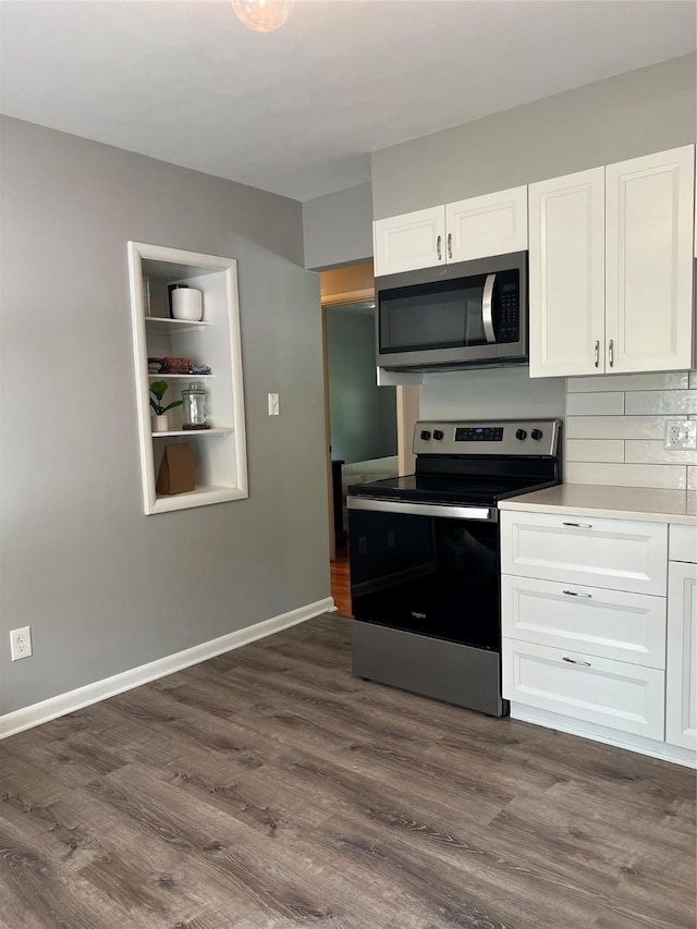 4301 43rd St, Des Moines, IA 50310 - kitchen with stainless steel appliances, white cabinets, dark wood-style flooring, and backsplash