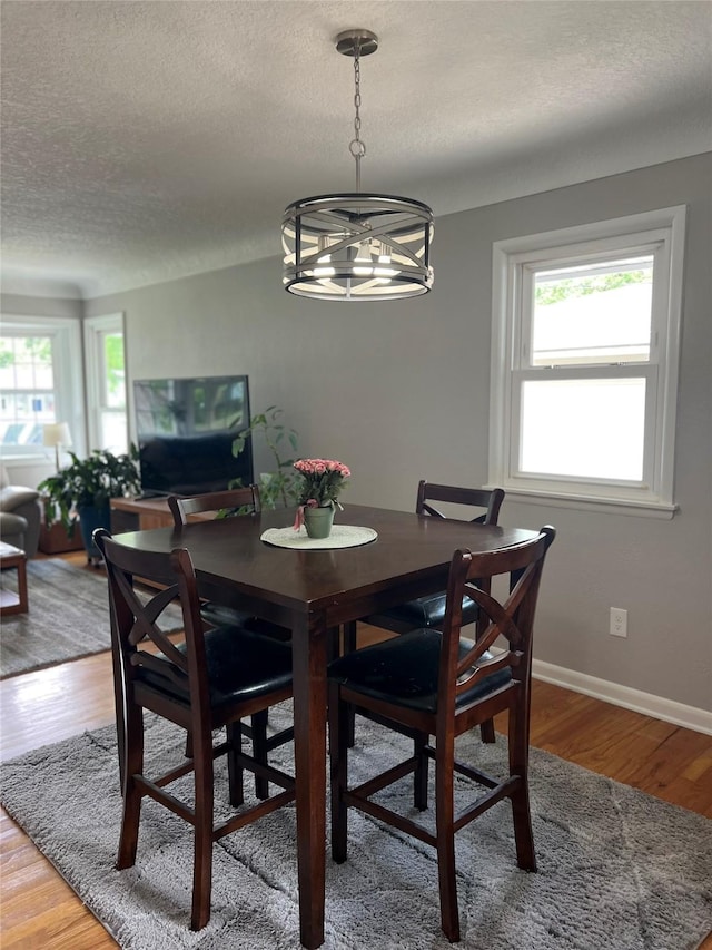 4301 43rd St, Des Moines, IA 50310 - dining area with a textured ceiling, a chandelier, and light wood finished floors