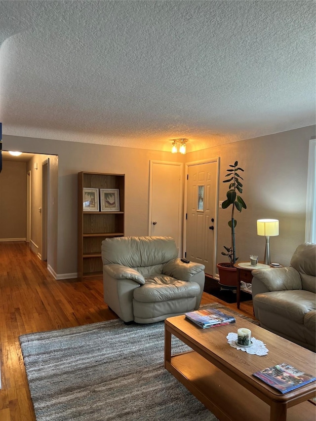 4301 43rd St, Des Moines, IA 50310 - living area featuring a textured ceiling and wood finished floors