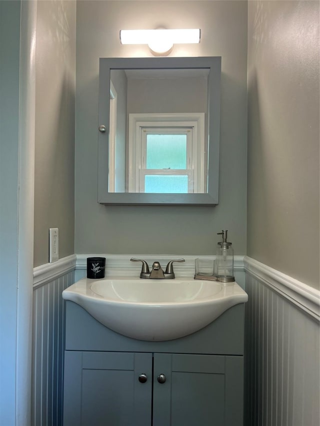 4301 43rd St, Des Moines, IA 50310 - bathroom featuring vanity, wainscoting, and a decorative wall