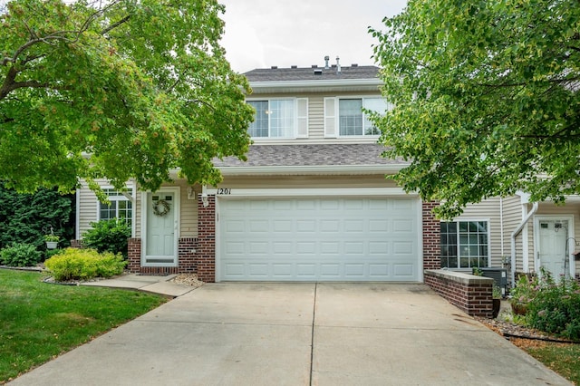 5221 Village Run Ave Unit 1201, Des Moines, IA 50317 - view of front of property featuring brick siding, a garage, and driveway