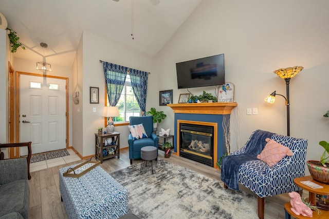 5221 Village Run Ave Unit 1201, Des Moines, IA 50317 - living room featuring wood finished floors, a glass covered fireplace, high vaulted ceiling, and a ceiling fan