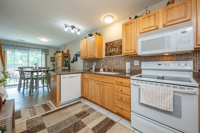 5221 Village Run Ave Unit 1201, Des Moines, IA 50317 - kitchen featuring white appliances, a peninsula, tasteful backsplash, dark countertops, and light brown cabinetry