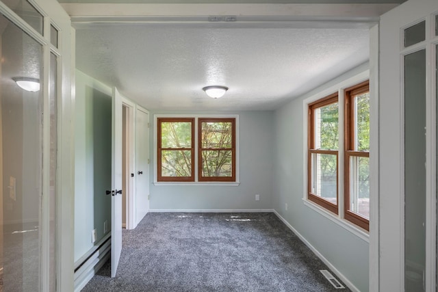 6730 NW Timberline Dr, Des Moines, IA 50313 - unfurnished room featuring dark colored carpet and a textured ceiling